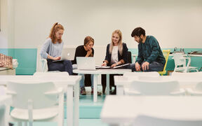 Four people gathered around a table