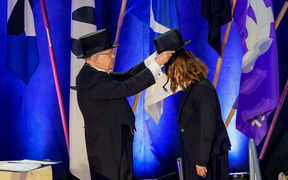 Ceremonial conferment, a doctor's hat is placed upon a Doctor's head