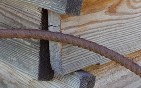 Reinforcing steel in front of a worn wooden structure
