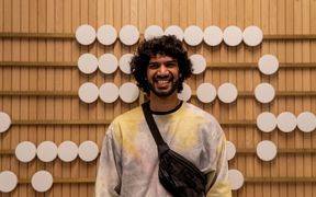 Mrinal pictured smiling in the lobby of Aalto University School of Business.