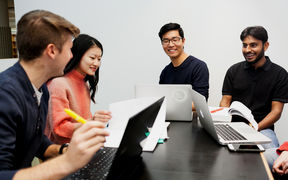 Students working at a common table. Photo by Aino Huovio.