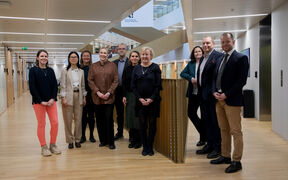 School of Business Alumni Advisory Board 2026 members pictured at the School of Business, in front of the staircase