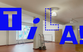 Empty indoor space with red floor, white walls, trolley and large blue word ‘TILA!’ overlaid