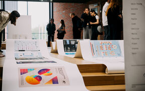 People view large infographic posters.