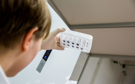 HealthTech biocompatibility Neuroncells on nanomaterials. A person looking at a sample.