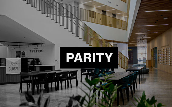 The picture shows the ground floor of the School of Business and it has the white text "parity" in a black box in the middle. 