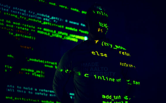 An illustration image with code and a human against a dark background.