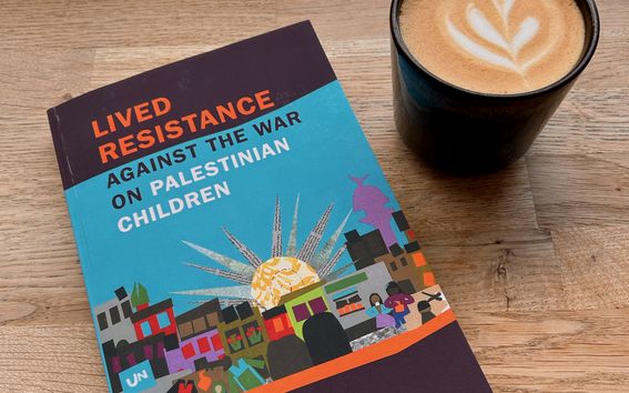 Lived Resistance against the War on Palestinian Children book on the table next to a cup of cappuccino