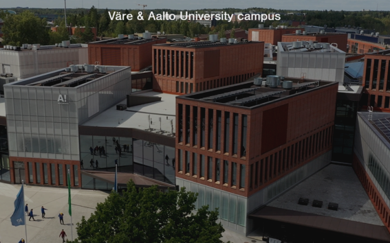 Aerial view of Väre and Aalto University campus with modern red and grey buildings and green surroundings.