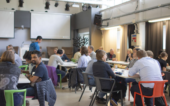 People discussing in groups.