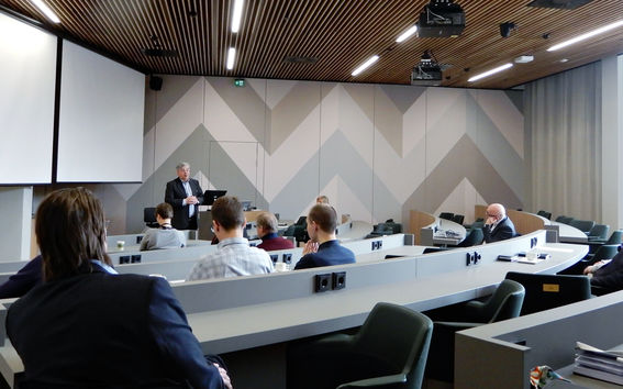 The photo shows people at the awarding ceremony.