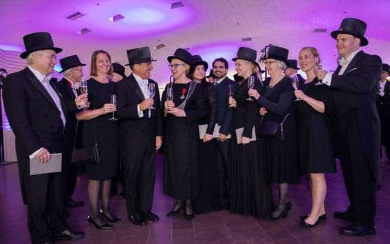 A group of doctors toasting at a Conferment party.