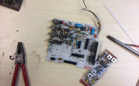 Disassembled circuit board with pliers