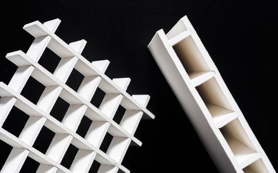 laminated white structures against a black background 