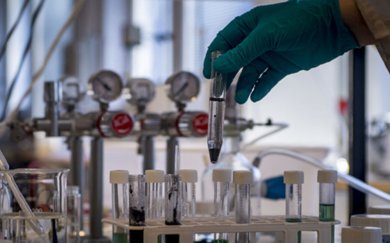 Precious metals in crushed batteries being dissolved in a test tube