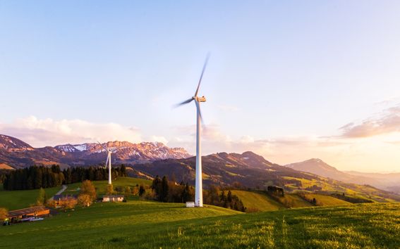 Two wind power plants in an alpine landscape