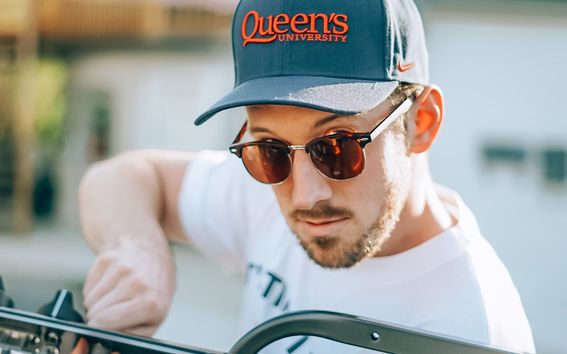 Kevin Campbell in sunglasses and a Queen's University cap