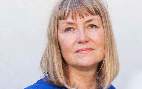 Photo of Professor Pirjo Kääriäinen in a blue shirt looking directly into the camera.