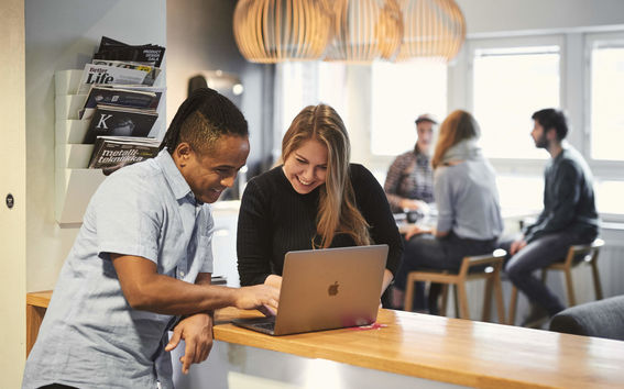 Two people looking at a laptop