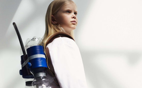 A young girl wearing a lab coat and looking to the future