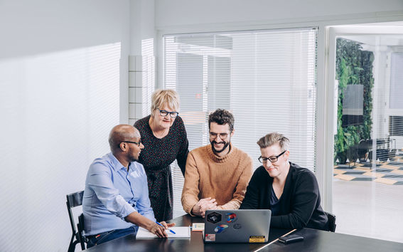 Four people looking at the laptop. Image: Aalto University / Aleksi Poutanen