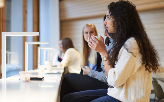 Aalto University students enjoying coffee on campus