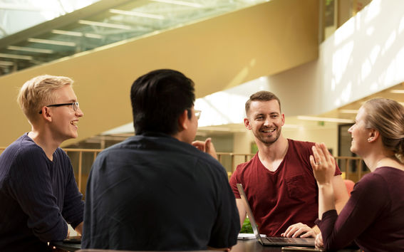 4 students sitting around table