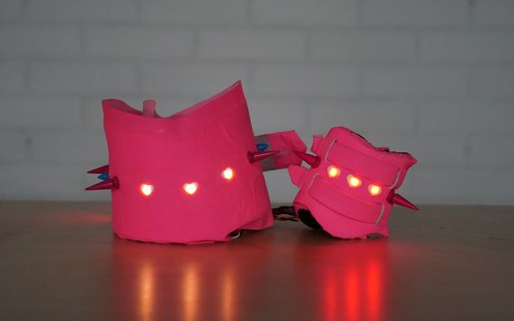 two pink objects with lights in the middle