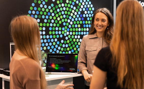 Three women discussing over a laptop