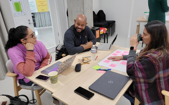 S group of students doing group work in a classroom setting.
