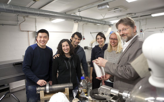 Professor Emeritus Herbert Sixta and members of the Ioncell team posing beside a Ioncell spinning machine