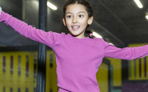 A girl jumping on a trampoline