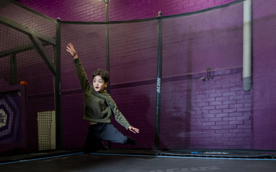 A boy jumping on a mixed reality trampoline in Superpark