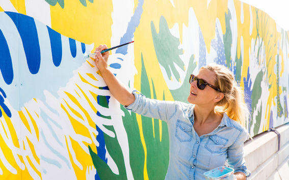 a woman painting a wall
