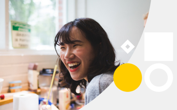 a laughing woman in an art workshop