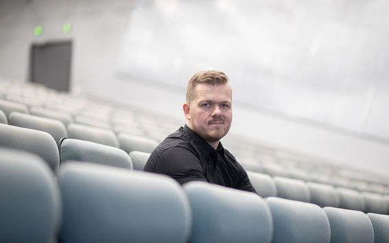 Sami Nieminen sitting in a lecture hall