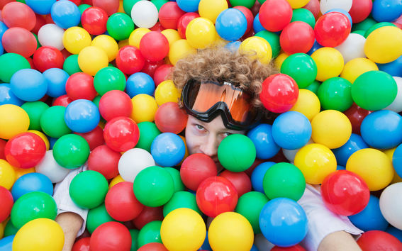 person with ski goggles in a ball pit