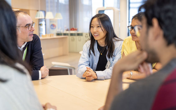 People sitting around a table talking.