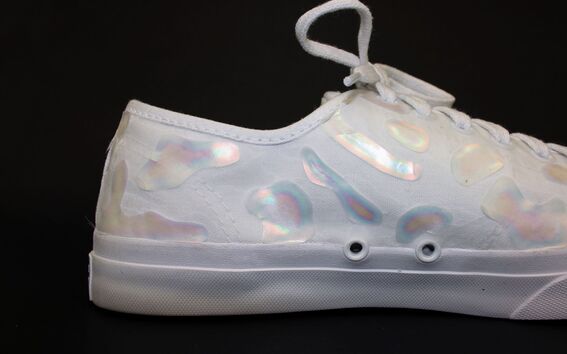 A white sneaker with glitter in the surface
