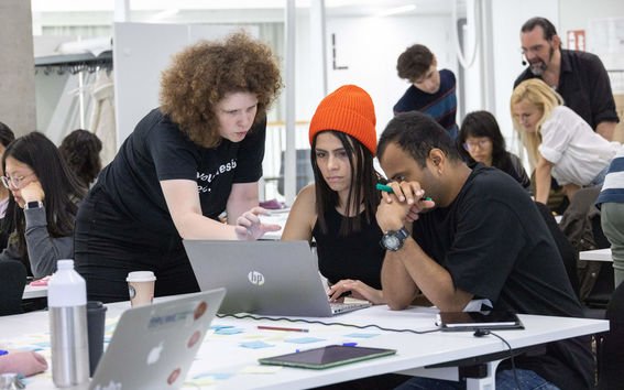 Students working together by a laptop