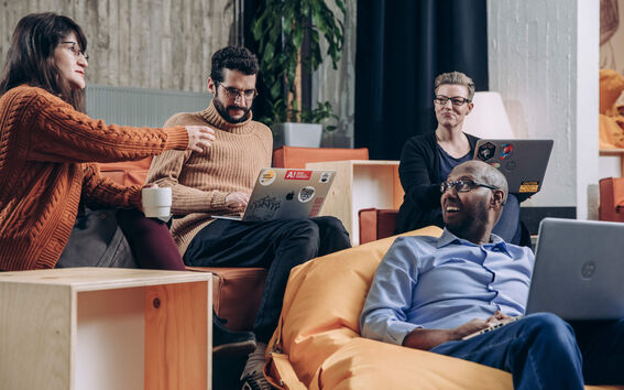 Aalto employees with laptops discussing