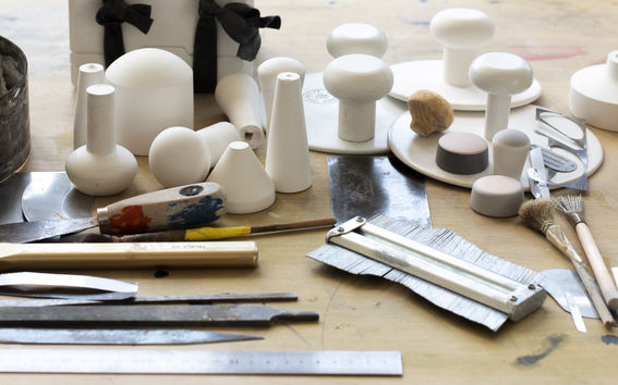 Workshop table full of tools for working with plaster and clay