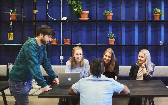 Five Aalto University students around a table