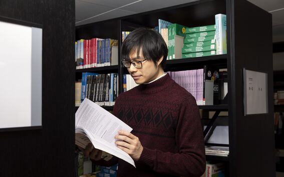Picture of a person reading a book.