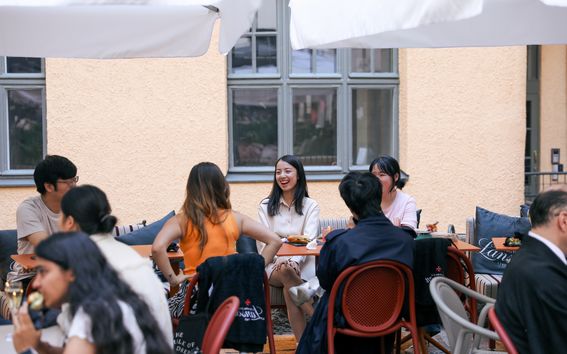 Summer School students chatting during a networking event in Helsinki