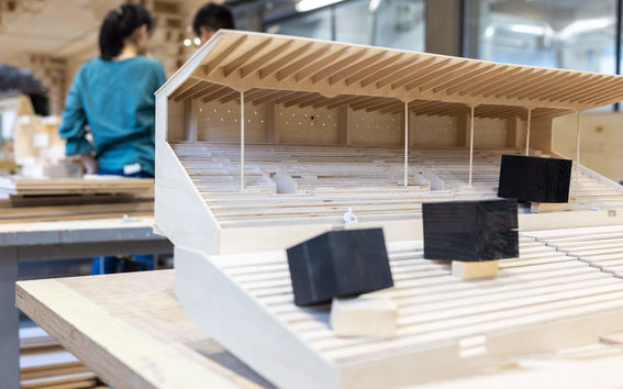 Close-up of a wooden model of a sports stadium.