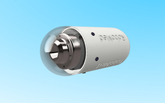 A cylindrical white capsule with a transparent dome, revealing metal components inside, on a gradient blue background.