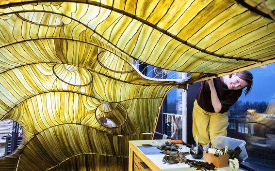 Julia Lohmann in her office with large seaweed sculpture