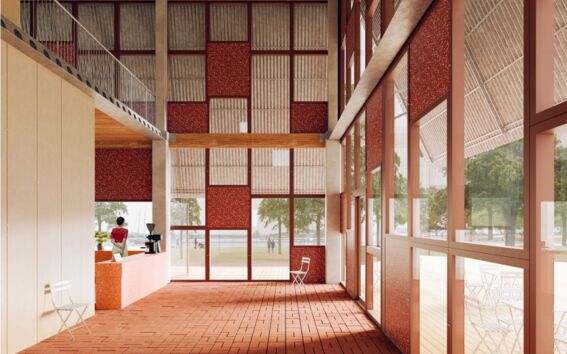 The Circular Drifter demohouse interior with large windows, red and white walls, and a person making coffee behind the counter.