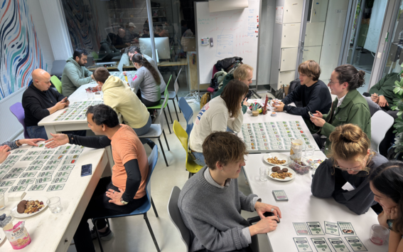 Students playing a board game at a Sustainability game night.